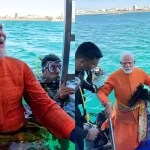 modi-immersed-in-water-dwarka-installs-peacock-feather